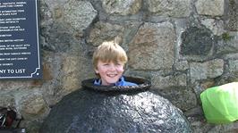 Olly tries out this ancient artefact at the Shipwreck Heritage Centre, Charlestown